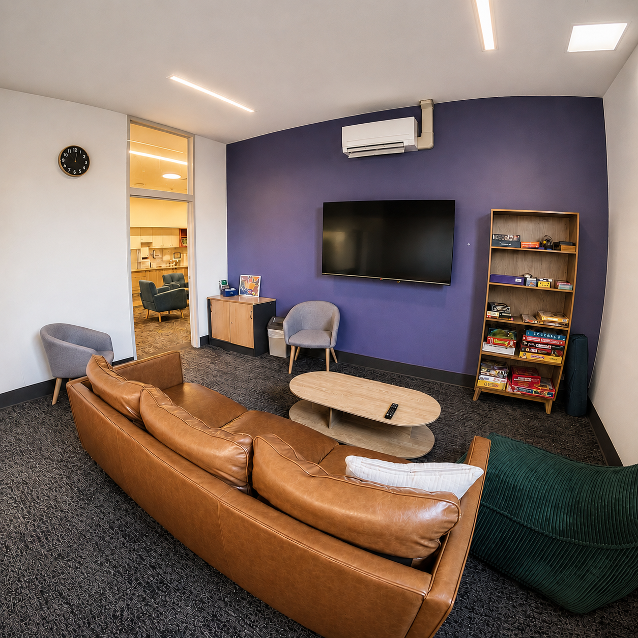 Essendon Private Clinic inpatient lounge room with sofa, seating, books and board games